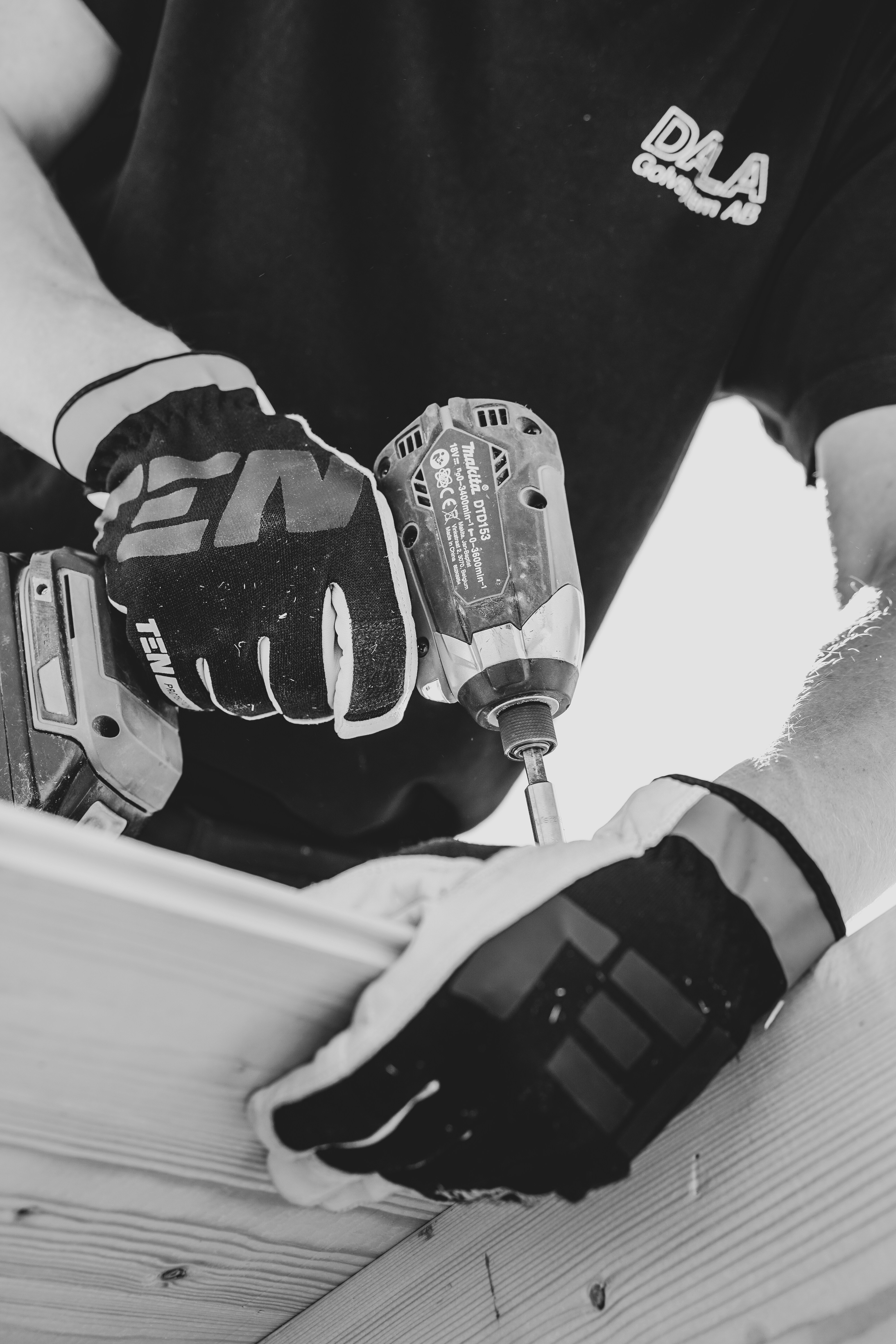 A man using an electric drill.